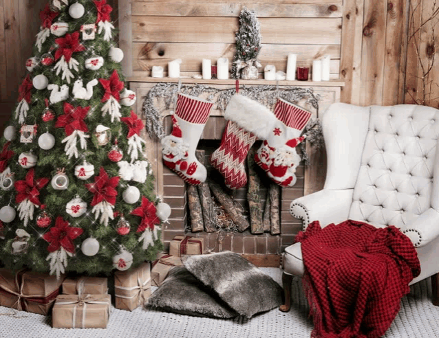 christmas stockings hanging on a fireplace with a christmas tree in the background