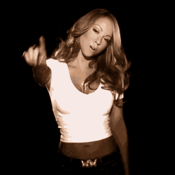 mariah carey is wearing a white crop top and giving the middle finger .