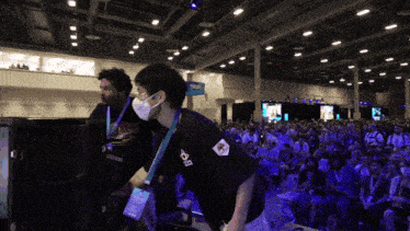a man wearing a mask has a lanyard around his neck that says ' ecg '