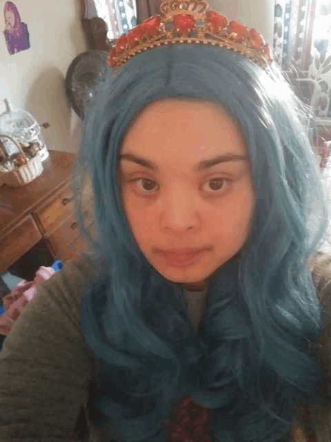 a woman wearing a blue wig and a gold tiara