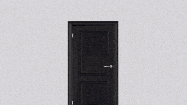 a man in a suit and tie stands in front of a door
