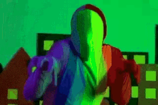 a person in a colorful costume is pointing at the camera