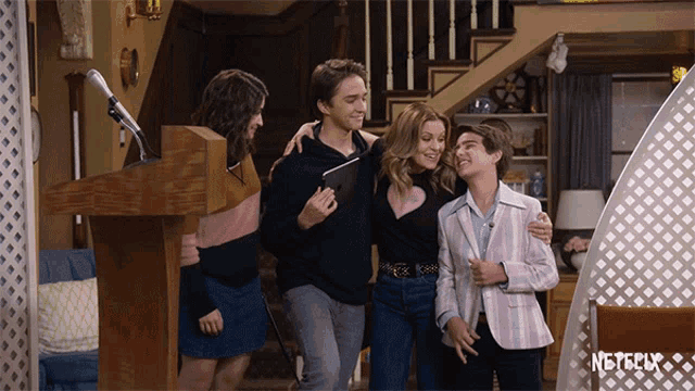 a group of people standing around a podium with the word netflix on the bottom