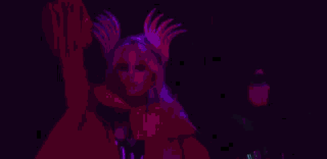 a woman is dancing in front of a large screen in a club while a man takes a picture of her .