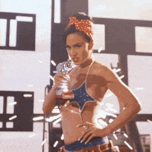 a woman in a bikini is holding a drill and sparks are flying