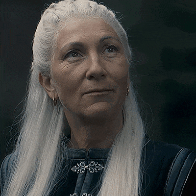 a close up of a woman with long white hair