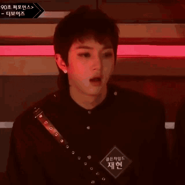 a young man wearing a black shirt with a name tag that says ' jeehyun ' on it
