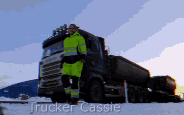 a trucker cassie is standing in front of a truck in the snow
