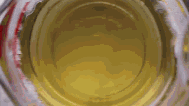 a close up of a yellow liquid in a measuring cup .