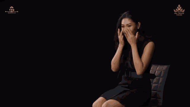 a woman in a black dress sits in a chair in front of a black background that says tpm on it