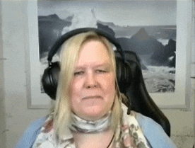 a woman wearing headphones is sitting in a chair in front of a picture