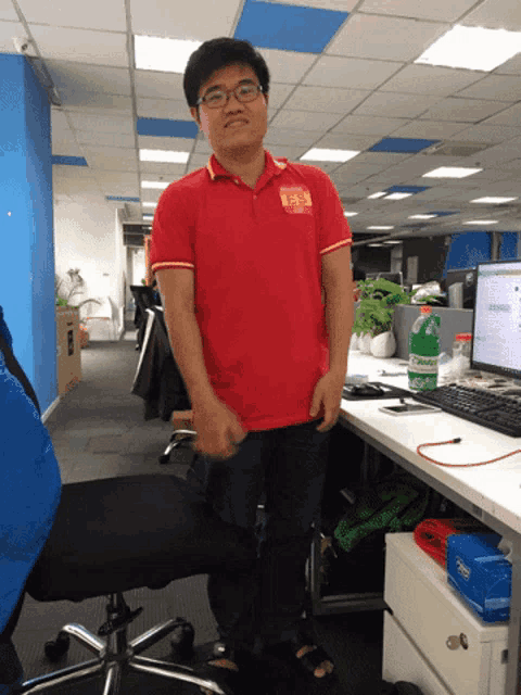 a man wearing a red shirt with a chinese symbol on it