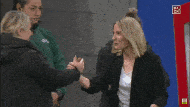 a woman in a black jacket with a badge that says ol