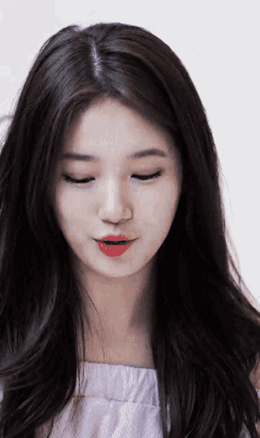 a close up of a woman 's face with her eyes closed and her mouth open