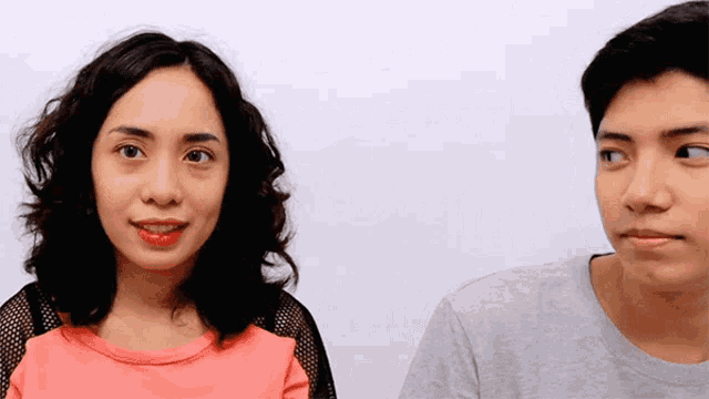 a man and a woman are looking at each other with their eyes closed