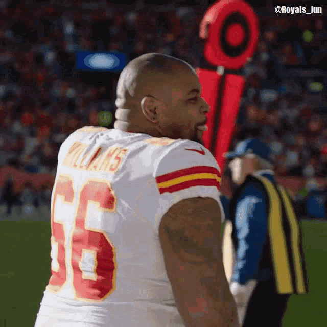 a football player wearing a jersey with the number 65 on it