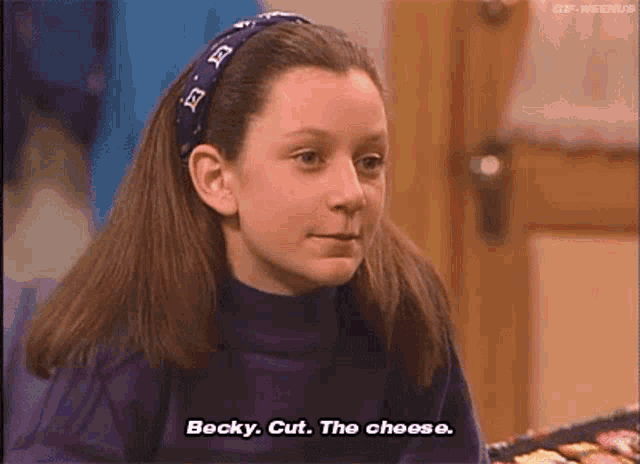 a young girl wearing a headband and a purple turtleneck is talking to becky .