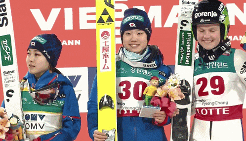 a group of skiers are posing for a picture and one has the number 30 on his shirt