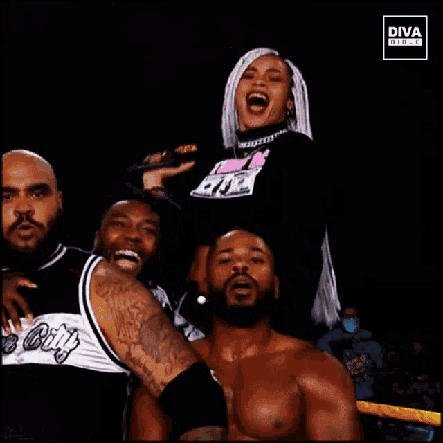 a group of wrestlers are standing in a ring with a diva girls logo in the corner