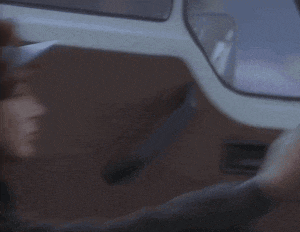 a woman is sitting in the back seat of a car wearing a hat .