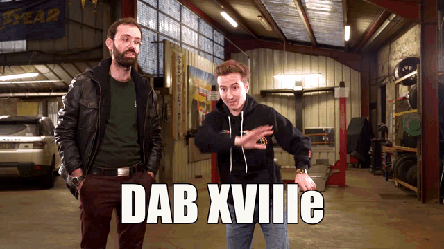 two men standing in a garage with the words dab xviiie on the bottom