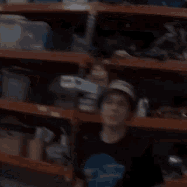 a man wearing a hat is holding a hammer in his hands