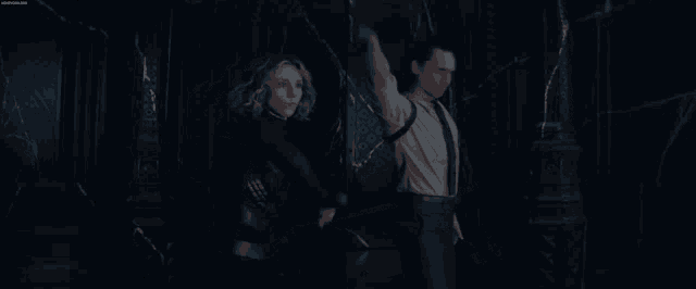 a man and a woman are standing next to each other holding swords .