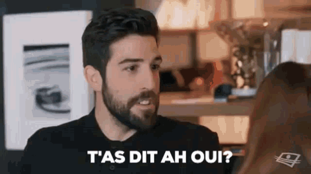 a man with a beard is talking to a woman and says `` t'as dit ah oui '' .