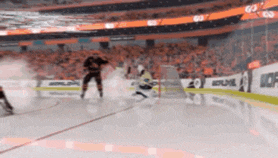a hockey game is being played in a stadium with a banner that says bauer