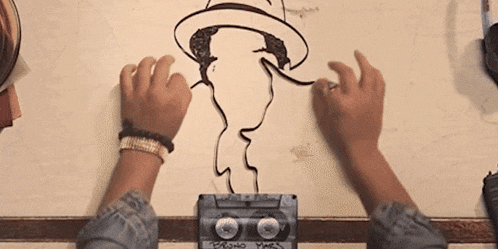 a person is drawing a picture of a man with a hat on a cassette tape that says pablo yes