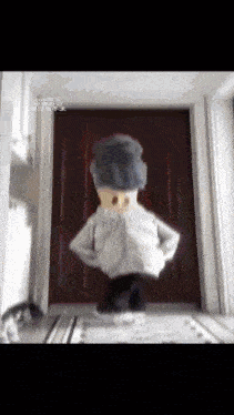 a cartoon character is standing in front of a door with chinese writing on it