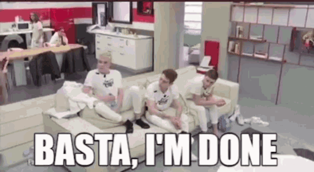 a group of people are sitting on a couch with the words basta i 'm done above them