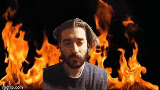 a man with a beard is standing in front of a fire with imgflip.com written on the bottom right