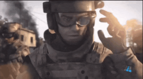 a soldier wearing goggles and a helmet with the number 14 on it