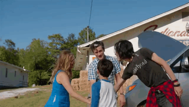 a group of people are standing in front of a building that says dirthead on it