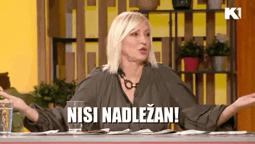 a woman sitting at a table with a glass of water and the words nisi nadlezan