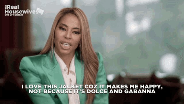 a woman in a green jacket is on a real housewives show