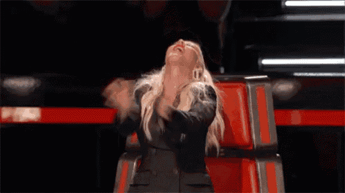 a woman is sitting in a chair with her legs crossed and her mouth open .