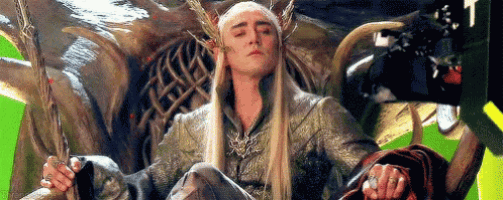 a man is sitting on a throne with his eyes closed .