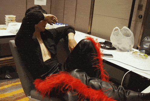 a man sits in a chair with his hand on his face