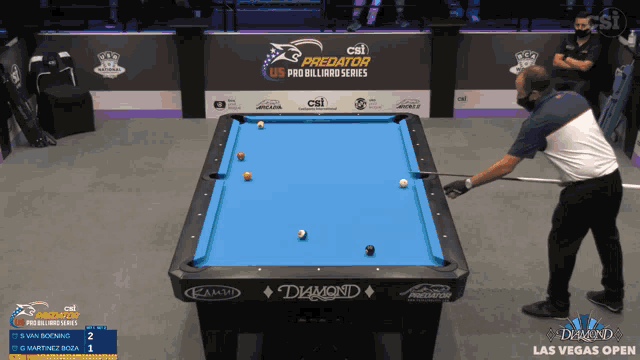 a man playing pool in front of a csi predator us pro billiard series sign