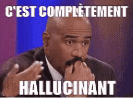 a man in a suit and tie with a mustache is making a funny face while holding his hands to his mouth .