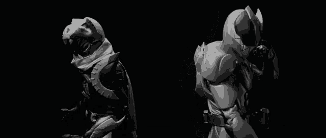 a black and white photo of two kamen riders standing next to each other .