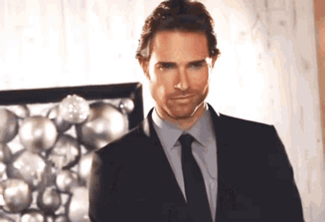 a man in a suit and tie is smiling