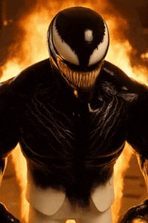 venom is standing in front of a fire in a room .
