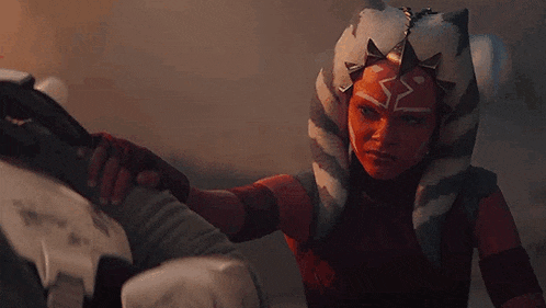a woman in a star wars costume is standing next to a man .