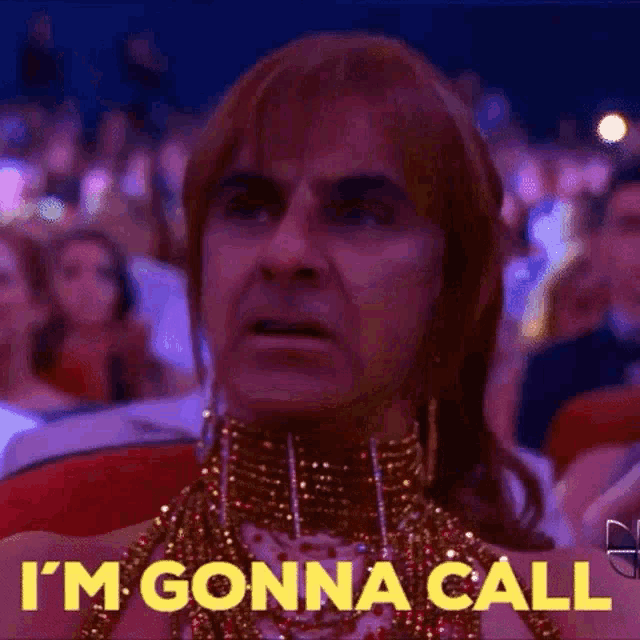 a man in a drag queen costume says i 'm gonna call in front of a crowd