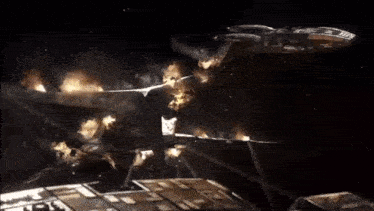 a plane is flying through the air with flames coming out of it 's wings .