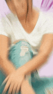 a blurry picture of a woman in a white shirt holding a blue blanket .