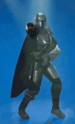 a man in armor with a cape is standing on one leg
